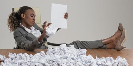 woman-reading-resumes-crumpling-ai-job-matching