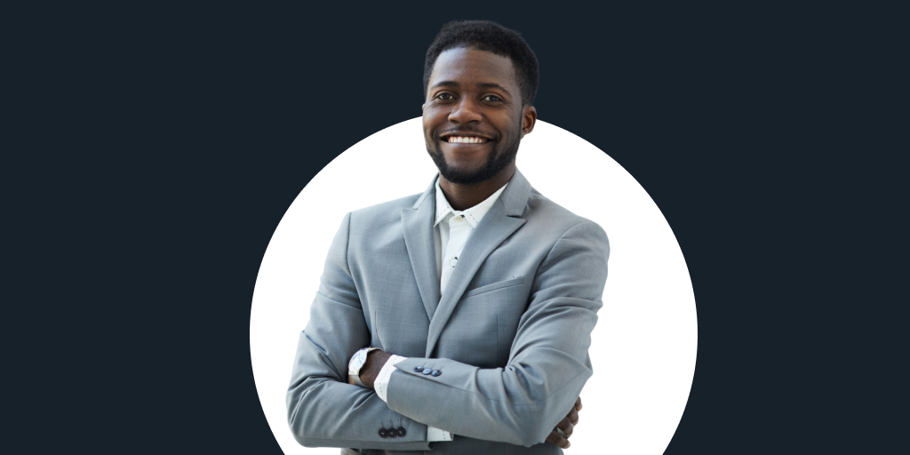 A smiling man in a suit, arms crossed looking at the camera