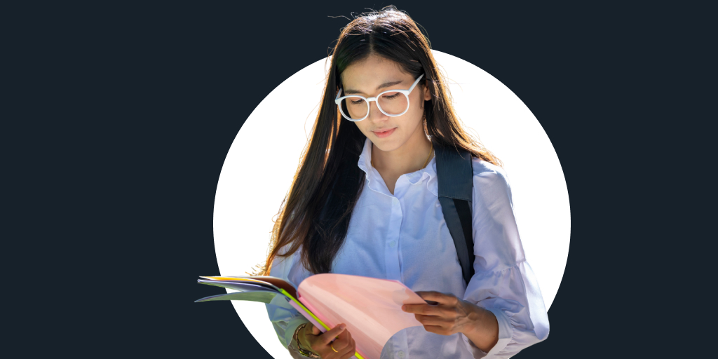 A young woman wearing a backpack while standing and reading