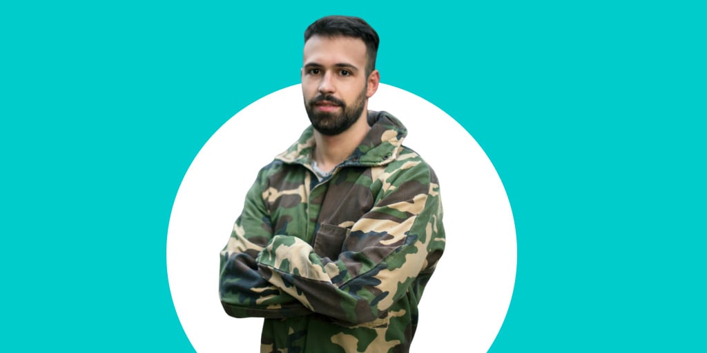 A middle-aged soldier in camouflage with his arms crossed