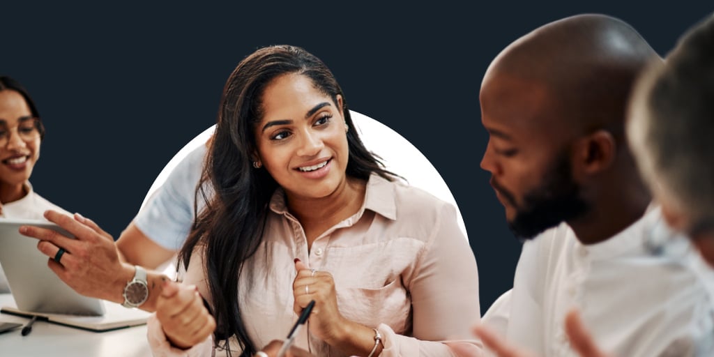 A group of young office workers collaborating together at a table