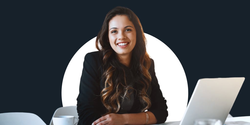 A young woman smiling in office attire