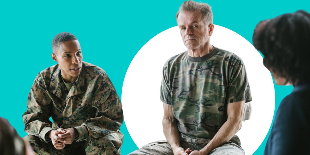 An older soldier in military camo sitting and talking with a younger group of soldiers