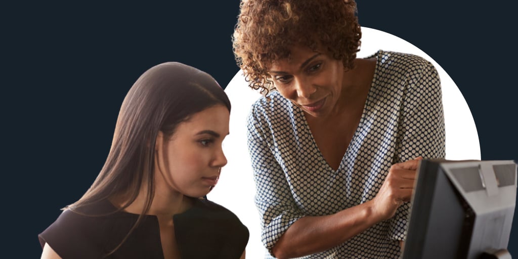 Two young woman collaborating in a work setting