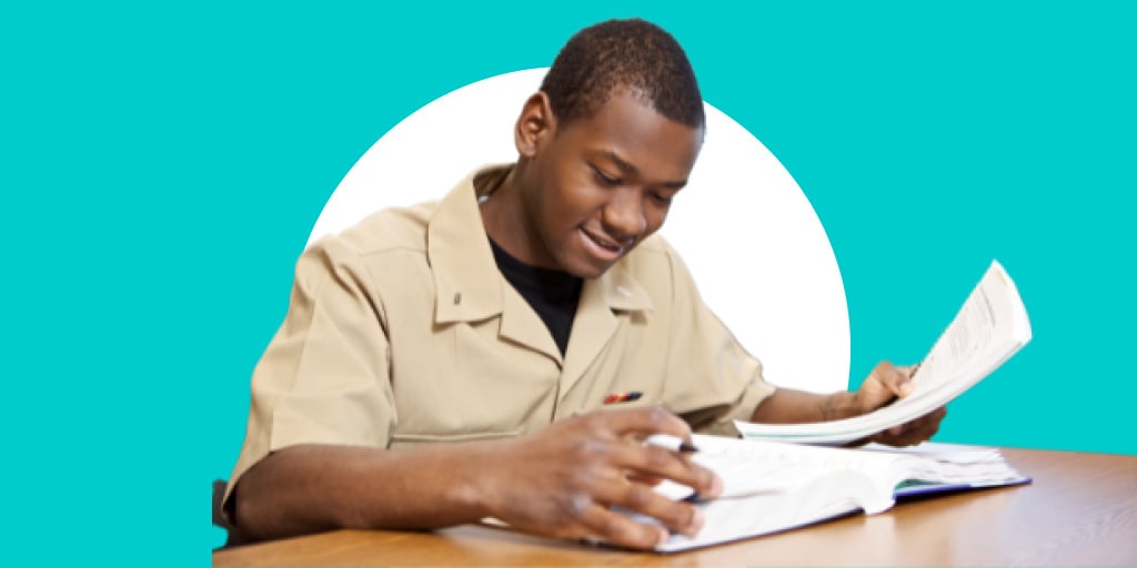 A soldier in a uniform signing papers