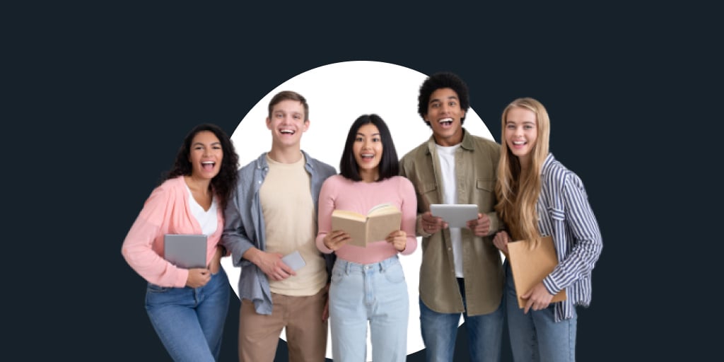 A group of students with work materials and books standing and smiling