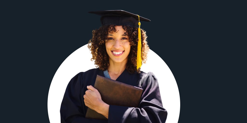 Young female student wearing a cap and gown for graduation