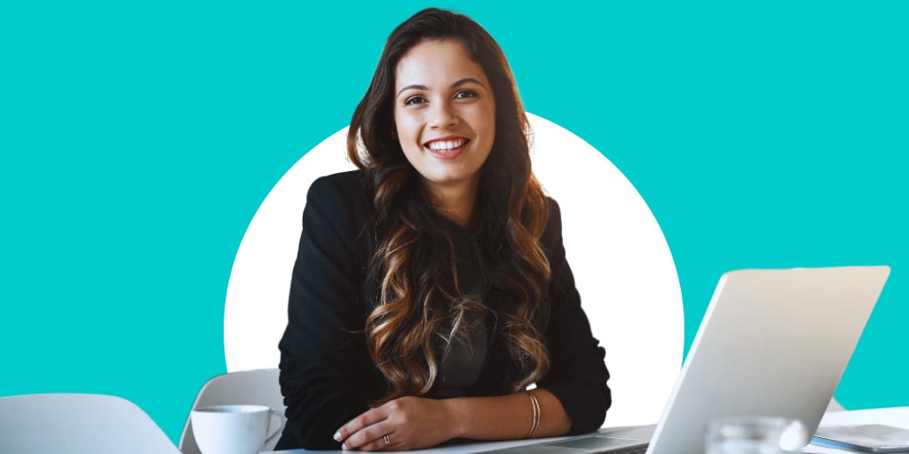 A woman sitting down smiling at a work station