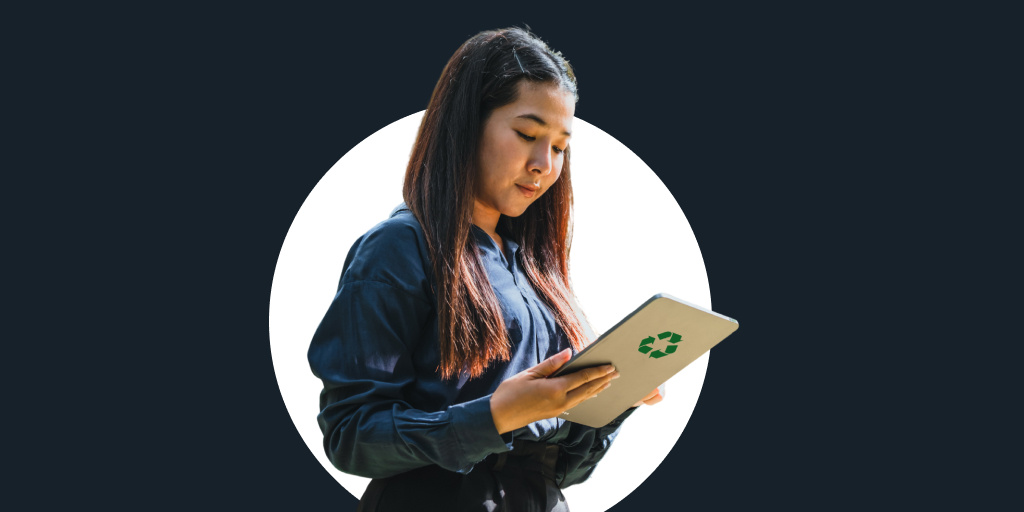 A young woman looking at a piece of paper with a recycling label on it