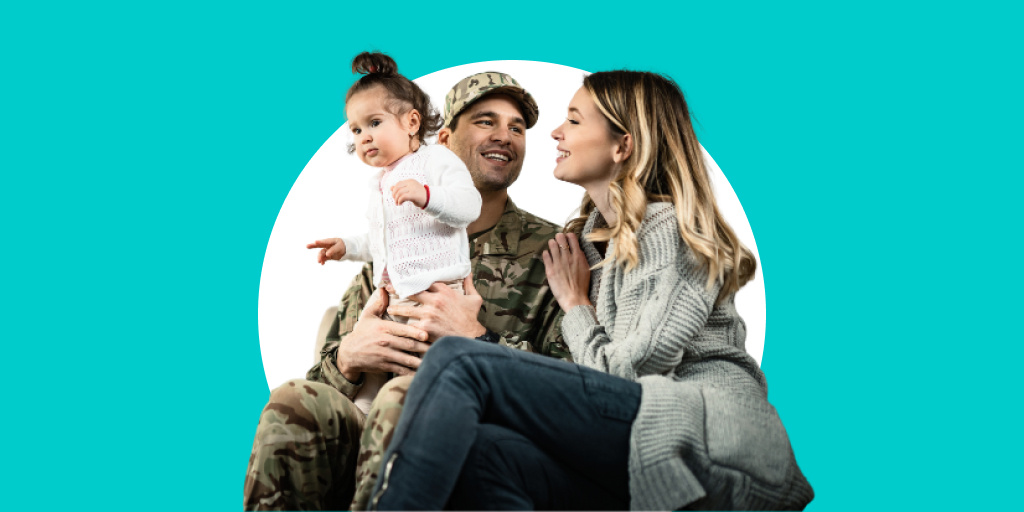 A soldier sitting with his family, with a child in his arms