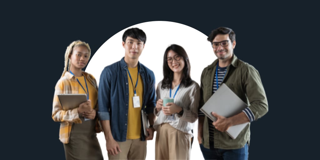 A group of four employees from different age ranges standing together