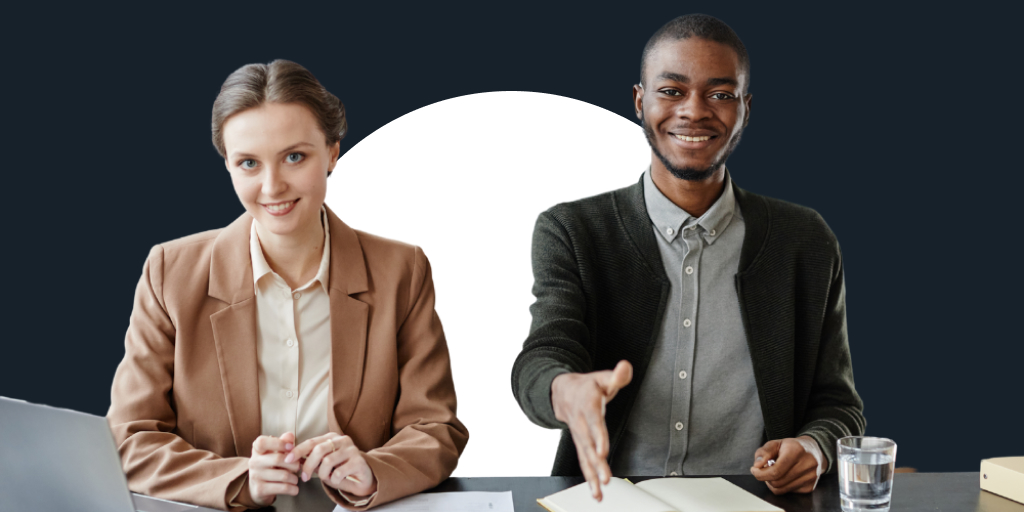 Two well-dressed workers, sitting with one extending their hand toward the camera