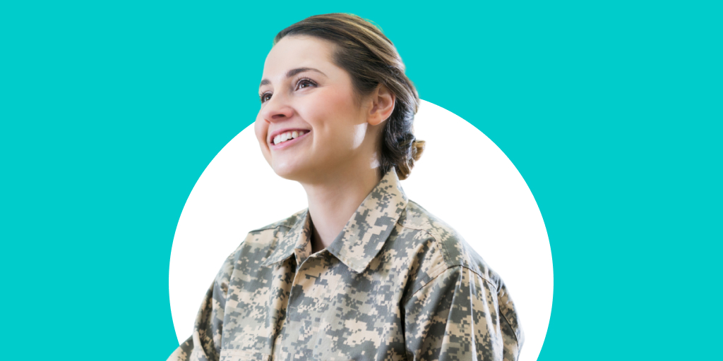 A soldier sitting, smiling as they look across to someone else