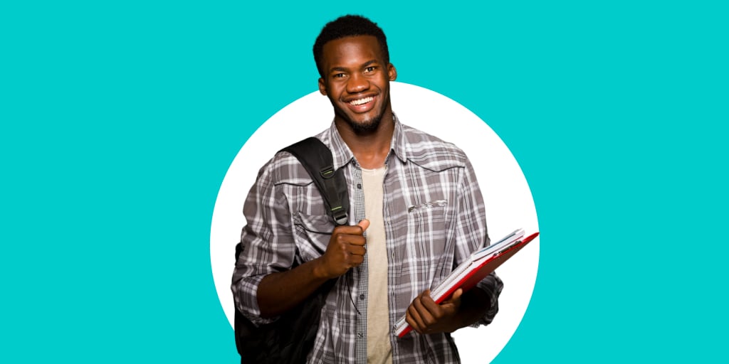 Adult wearing a backpack holding a notebook