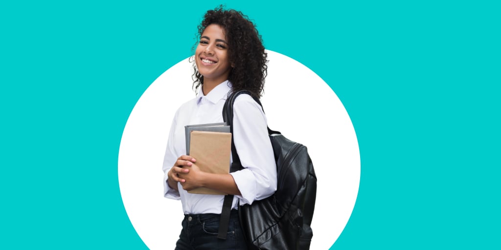 A young adult with a backpack and notebook in hand as they walk