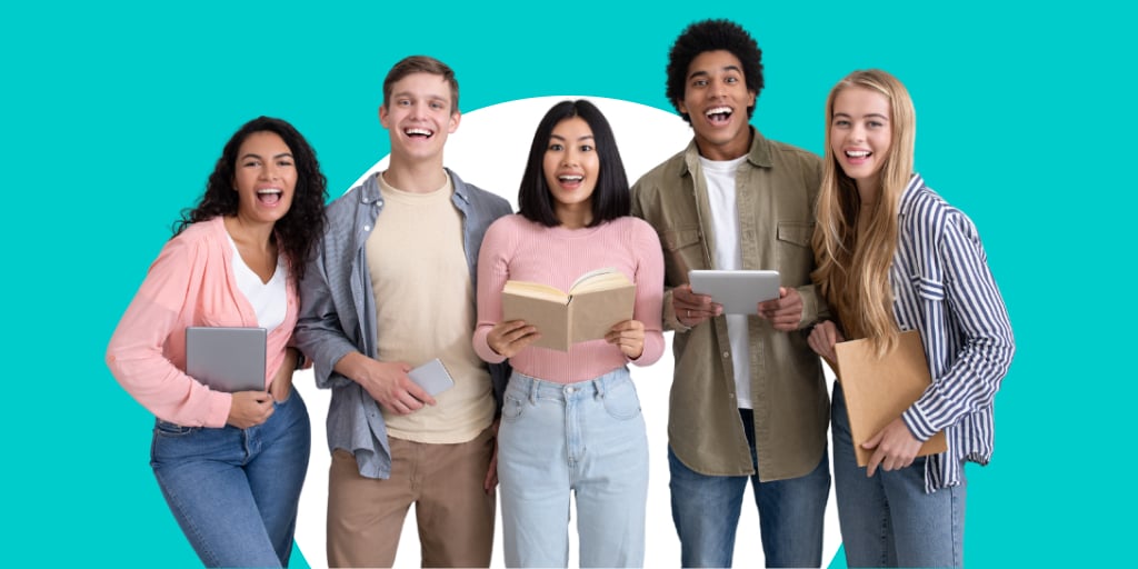 A group of young teens gathered together with notebooks and books in their hands as they read and smile