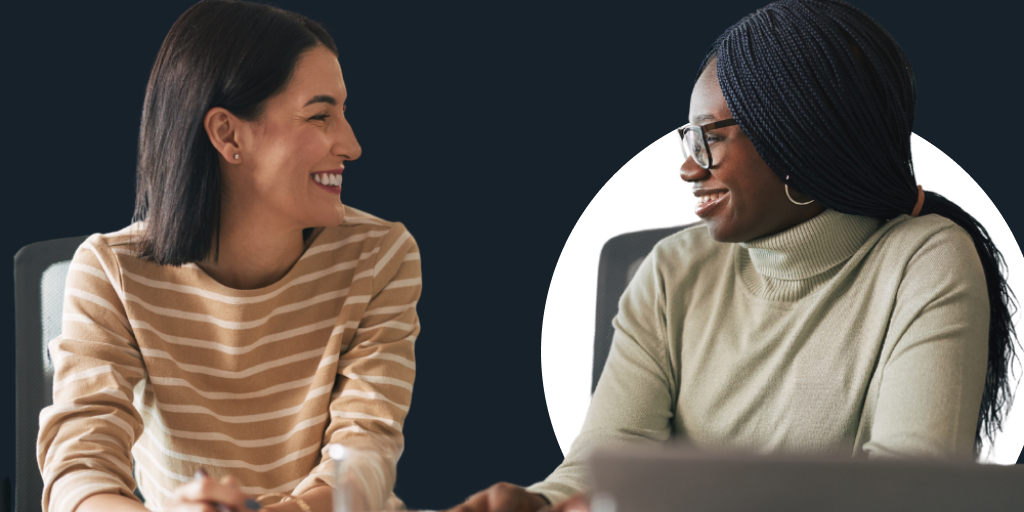 Two teachers sitting talking to each other and laughing