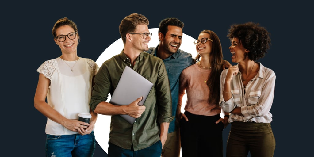 A group of workers, all walking together as they hold notebooks, laptops and devices