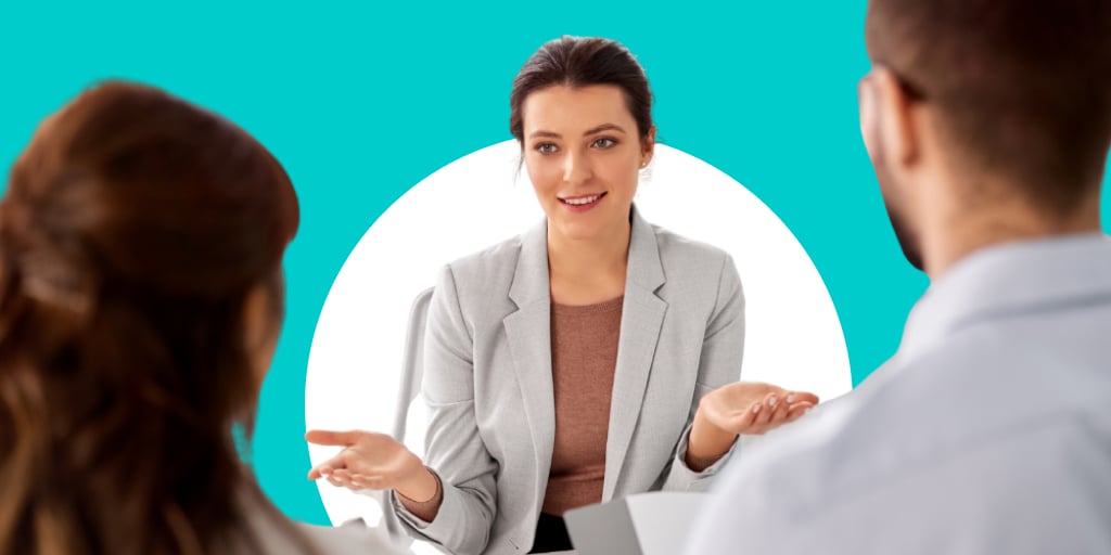 An older adult sitting down talking with two interviewees