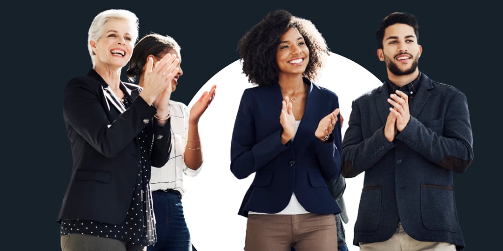 Group of professionally dressed workers standing around in a circle, talking