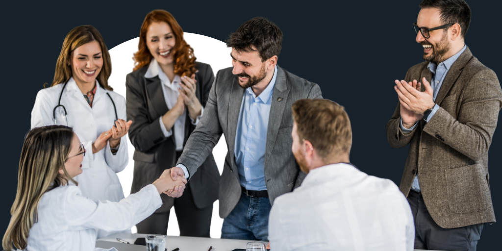 Group of people all meeting together, with some shaking hands with one another