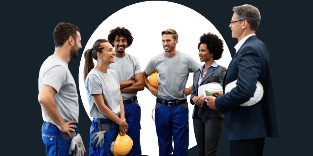 Group of people, some with notebooks, other with construction helmets all gathered around talking