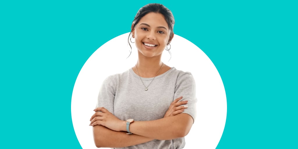 A woman smiling with arms crossed
