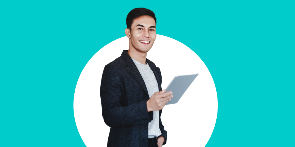 A young, well-dressed professional smiling and holding a tablet or device in their hand