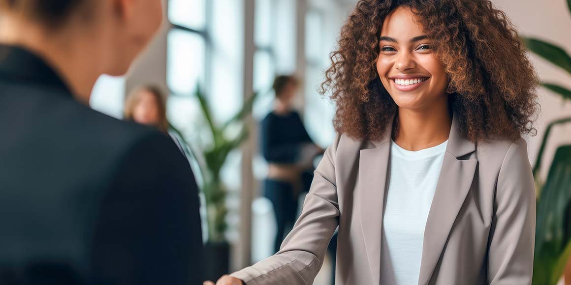 Businessperson recruiting a younger candidate for a job.